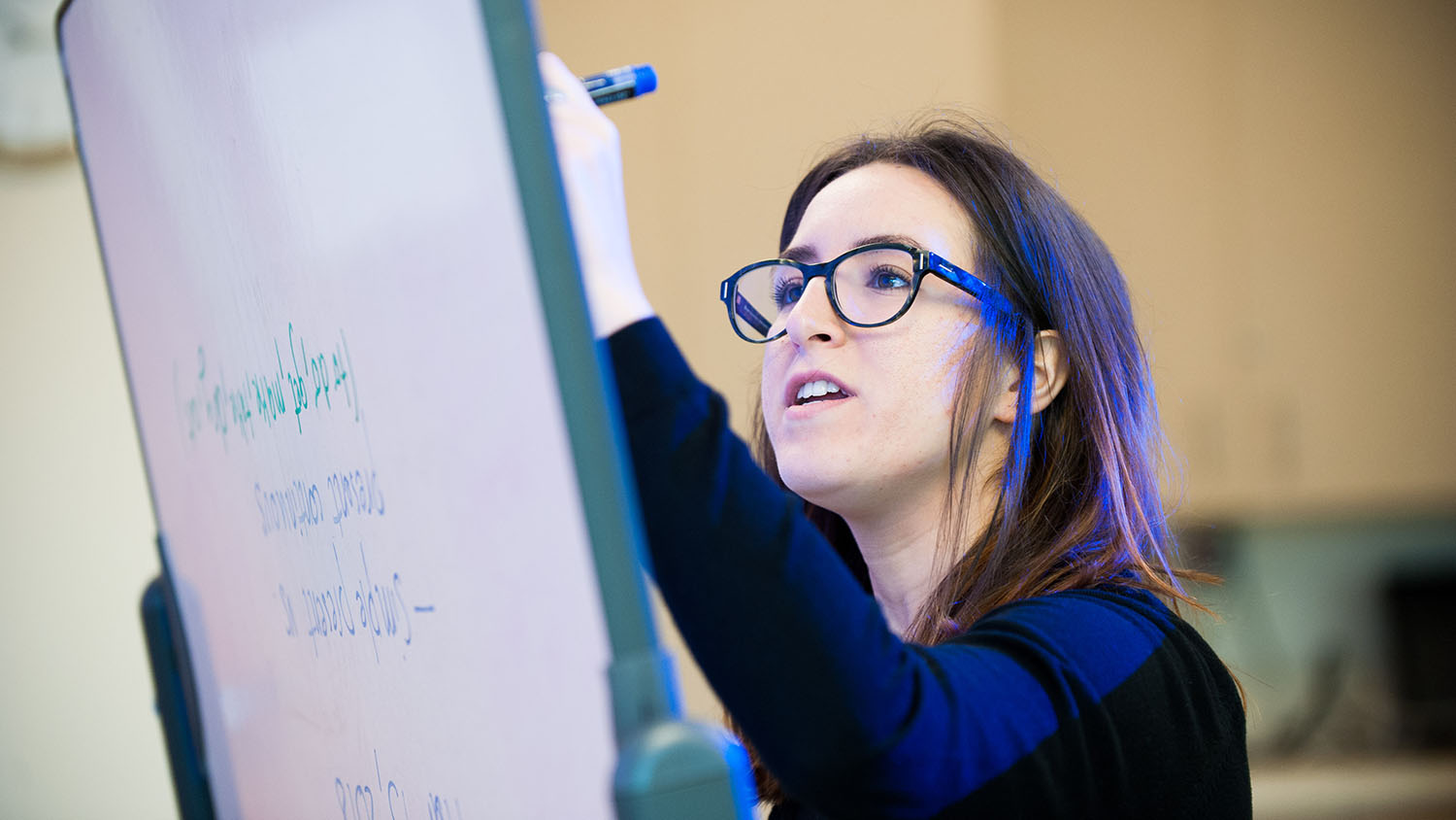 Student working on a whiteboard